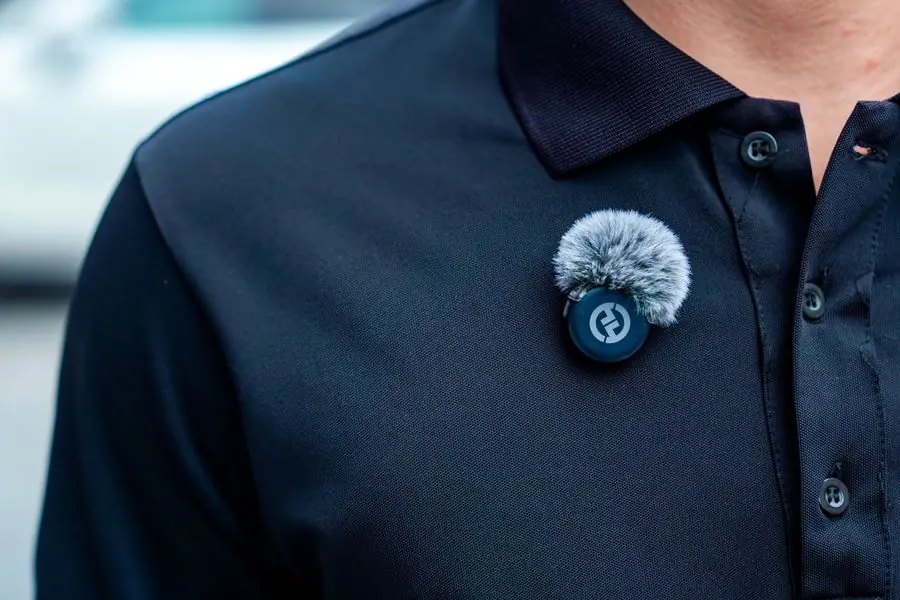 Person wearing a wireless clip-on microphone